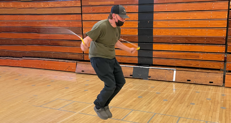 A student jumping rope in PE class.