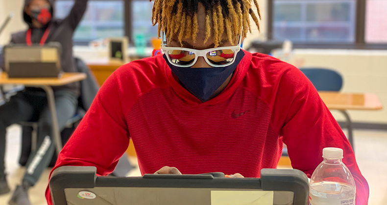 high school student staring at laptop