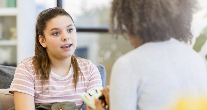 Teenage girl talks to school counselor