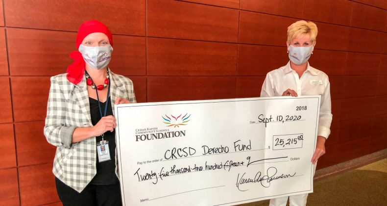 Karen Swanson and Noreen Bush holding a large donation check