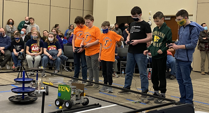 Two teams work together in the Robot Rumble.