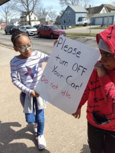 Green Team members educate drivers about the district "No Idle" directive to reduce air pollution.