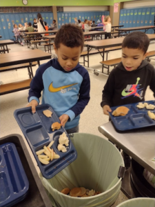 Students sort meal waste for reusing, recycling, composting or landfilling.