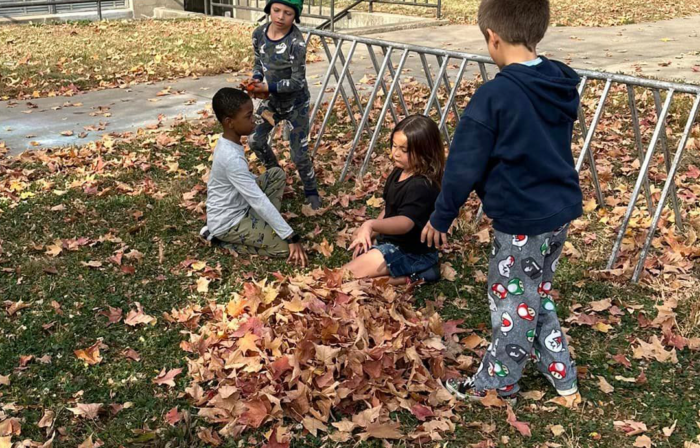 Cleveland students playing in leaves 2024