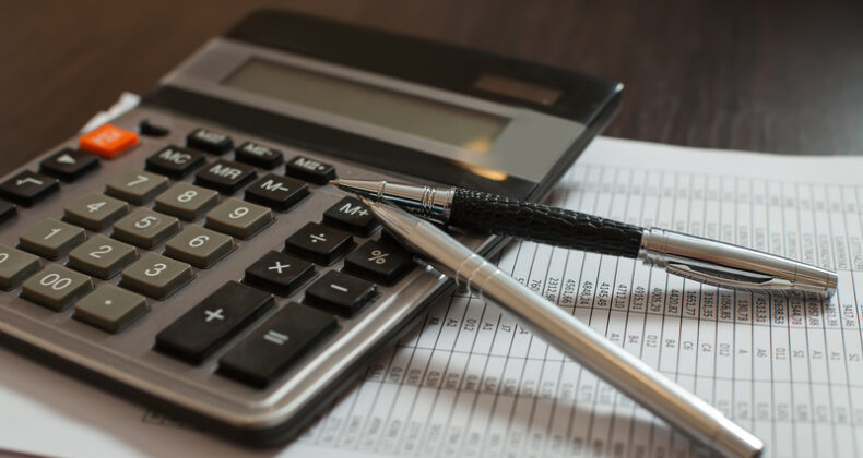 Decorative image: Accounting documents, pens and calculator closeup