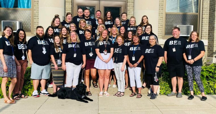 Garfield staff on front steps with their Be tshirts