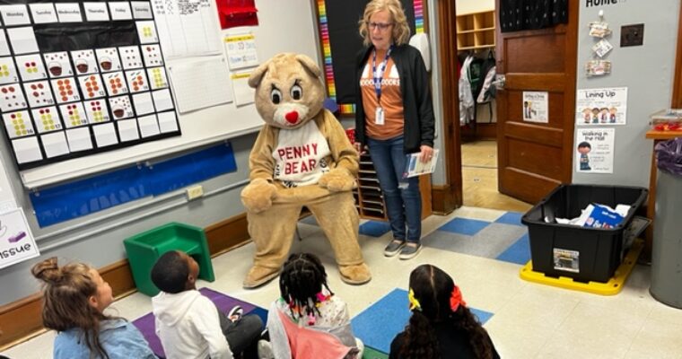 Penny bear and Mrs. Long read to 2nd grade