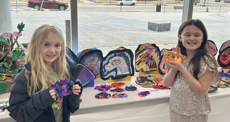 Two Grant students show their artwork.