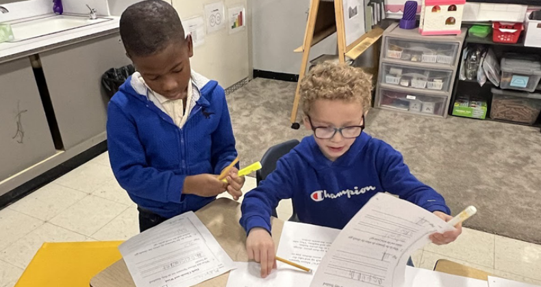 Two Grant students work on a project together.