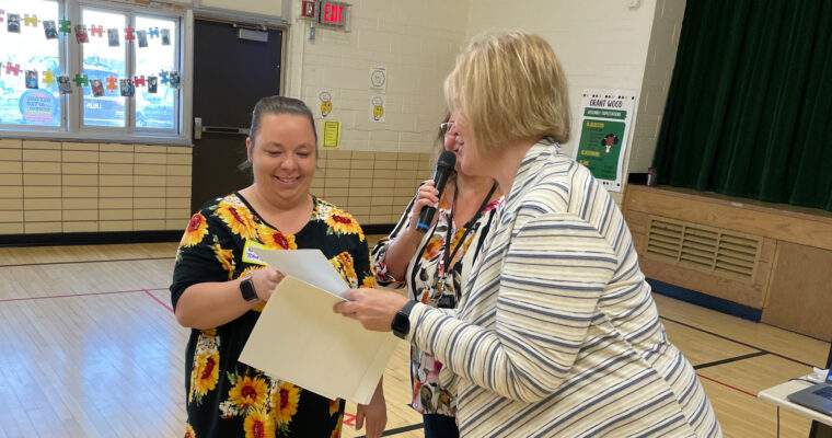 Volunteer receiving certificate from Principal, Cynthia Stock