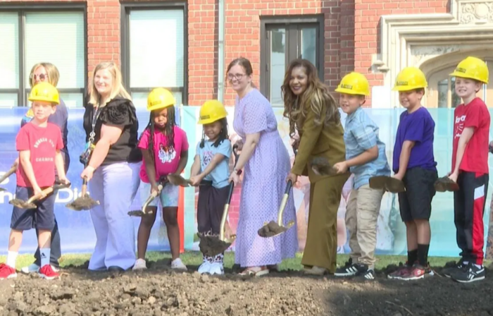 Harrison elementary staff and students standing on dirt for groundbreaking ceremony