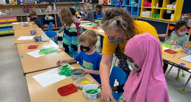 Teacher working with students.