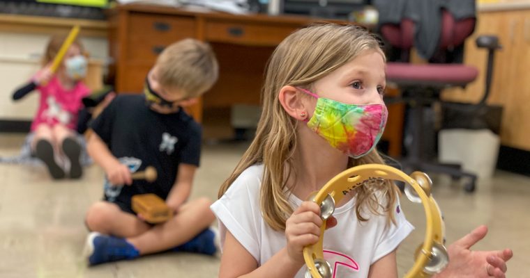 Music Class girl playing tambourine