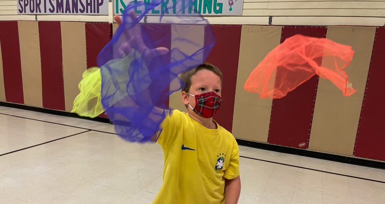 Student catching scarves.