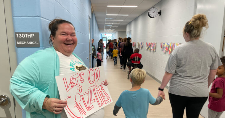 Walk-a-thon students being cheered on with sign