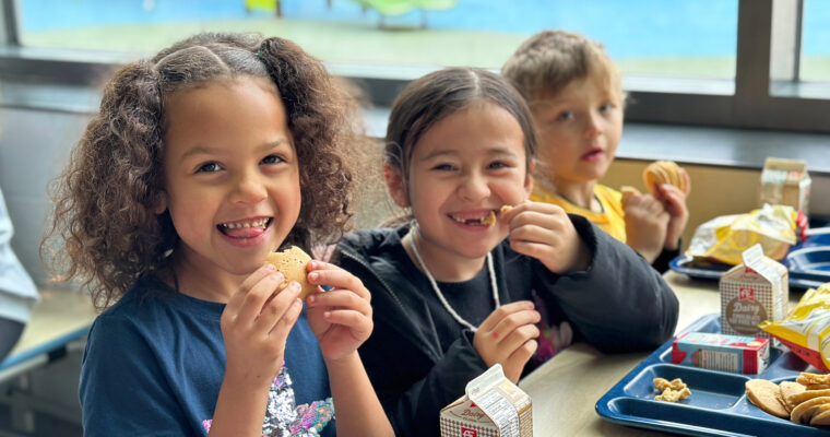 Students smiling eating breakfast