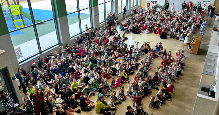 A picture taken overlooking the Maple Grove cafeteria and meeting space. With almost the entire student body sitting.