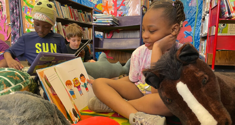 student holding book