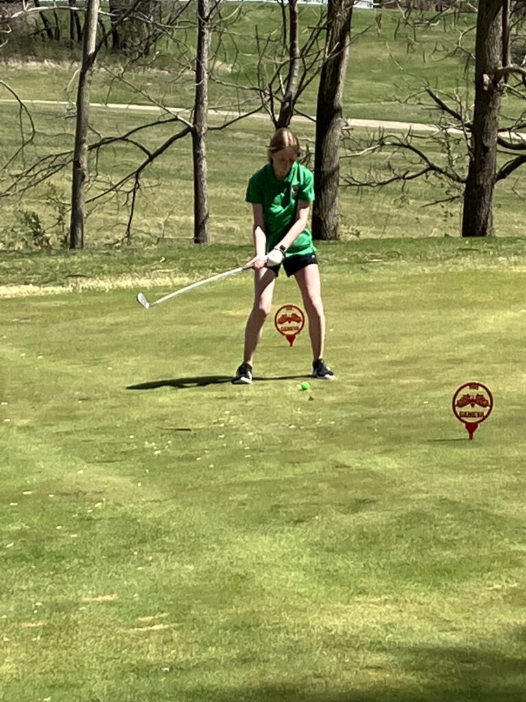 Girl's golfer hits a tee shot