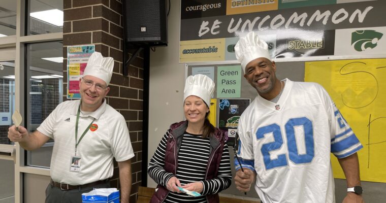 Administrators make pancakes for a staff work day