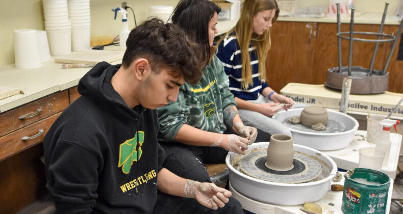 students work with clay