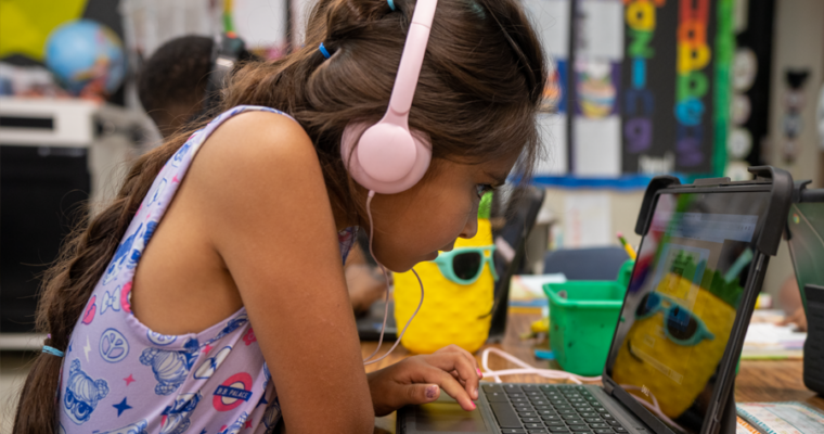 A Nixon student looks deeply into her chromebook studying a lesson.