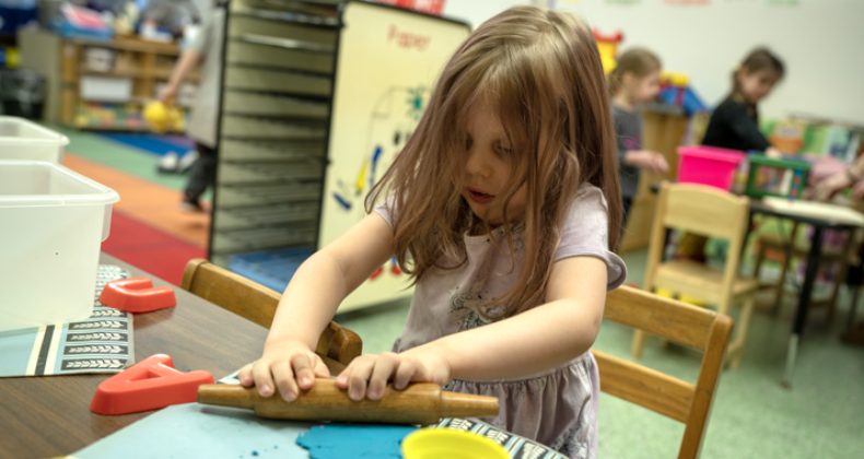 A student playing with clay.