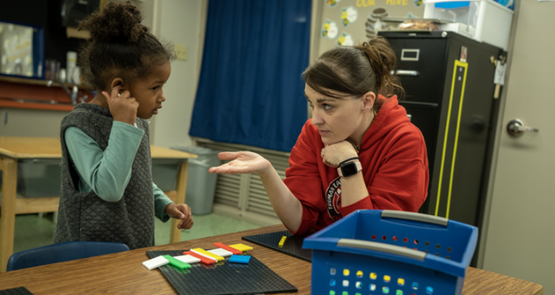 A Truman staff member works with a student.