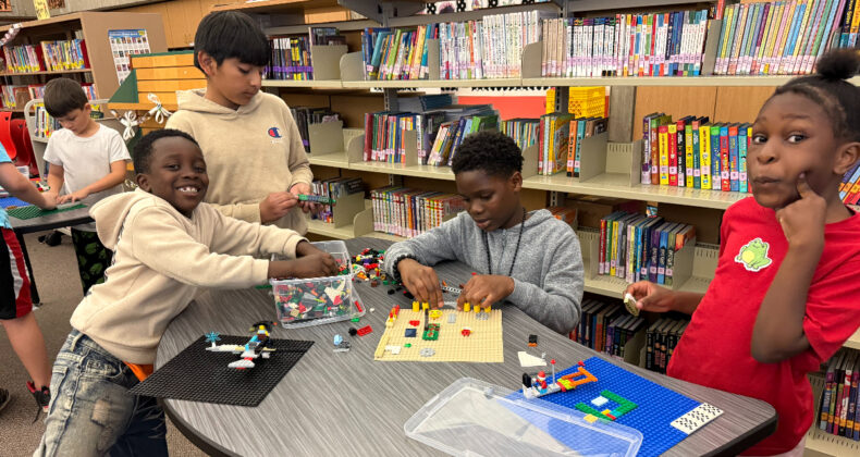 Students showing off their lego creation