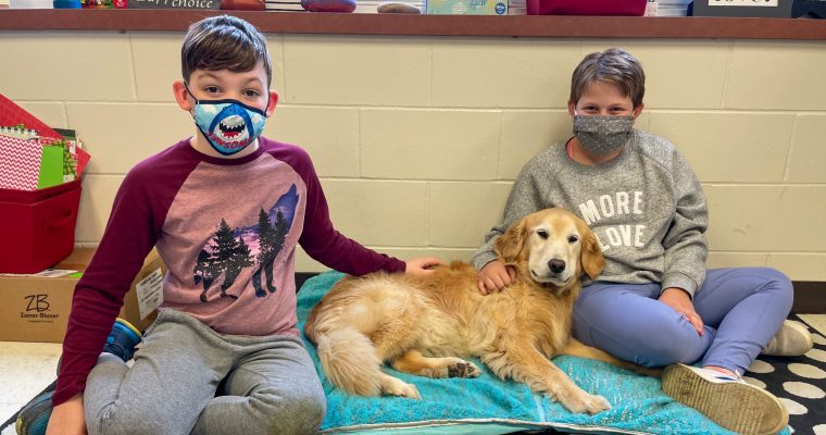 two students wearing masks with dog