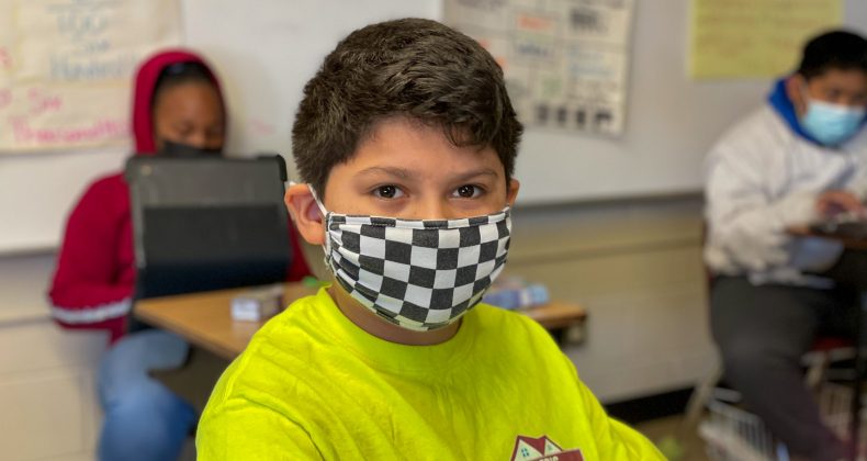 Student smiling through mask