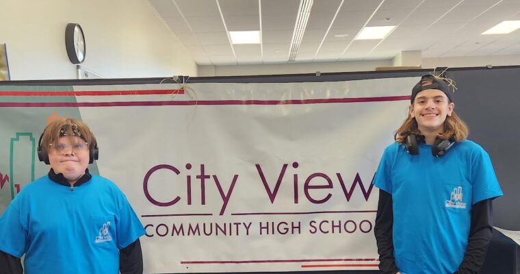 City View students smile in front of the City View sign.
