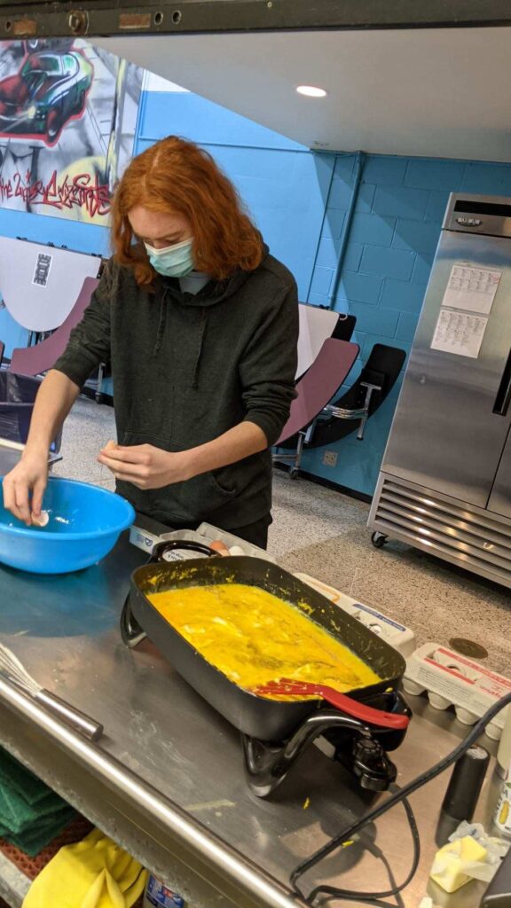 Students help with preparing breakfast.