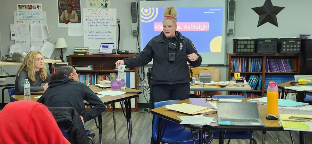 Students learning how an officer dusts for fingerprints
