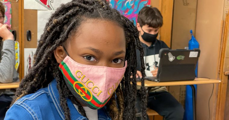 student smiling wearing a mask