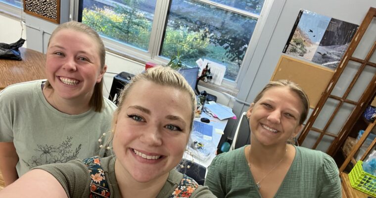 Staff members smiling before classes